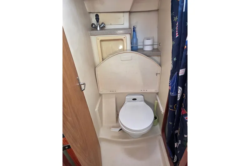 Slide: The Image of Cozy interior of 2000 Hunter 460 sailboat with cushioned seating and wooden table. - 13