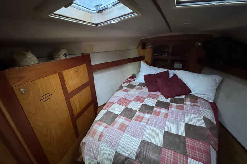 Slide: The Image of Interior of a 2000 Hunter 460 sailboat with cozy seating and wooden accents. - 17