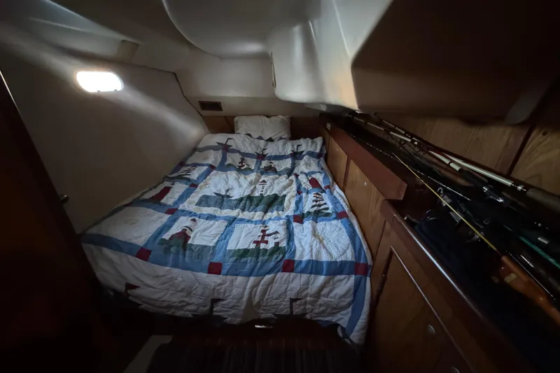 Slide: The Image of Interior of a 2000 Hunter 460 sailboat kitchen with wooden cabinetry and stainless steel sink. - 18