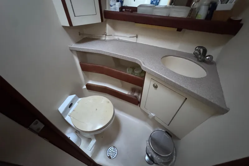 Slide: The Image of Interior of 2000 Hunter 460 yacht kitchen with stove, sink, and wooden cabinetry. - 21