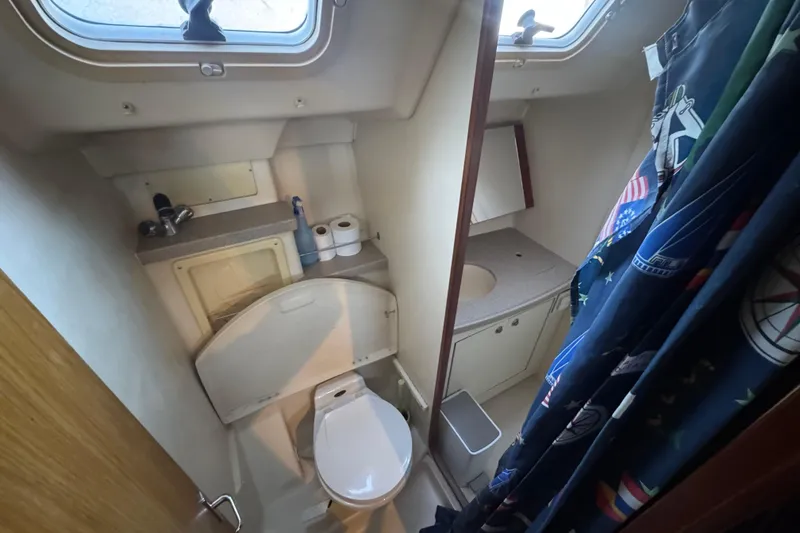 Slide: The Image of Galley of 2000 Hunter 460 yacht with open fridge, stocked with canned drinks. - 22