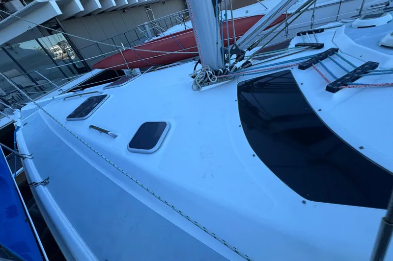 Slide: The Image of Compact bathroom in a 2000 Hunter 460 yacht with toilet, sink, and nautical-themed shower curtain. - 26