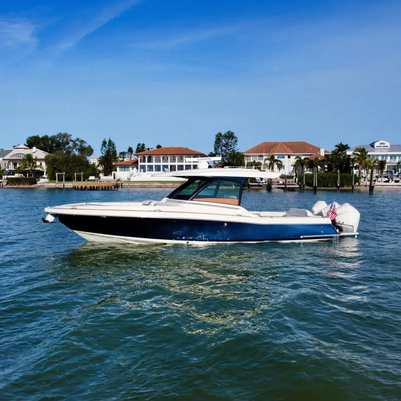 The Image of 2021 Chris-Craft Calypso 35 on calm water near coastal homes. - 0