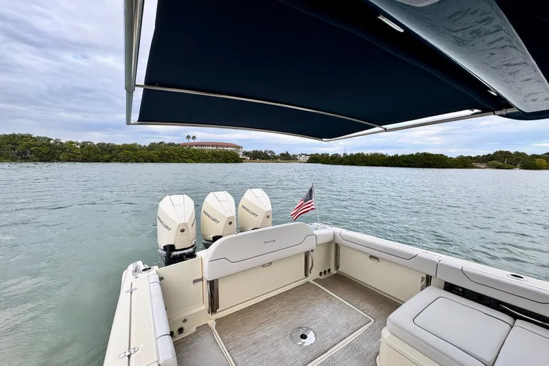 Slide: The Image of 2021 Chris-Craft Calypso 35 boat with triple Mercury engines on a calm lake. - 12