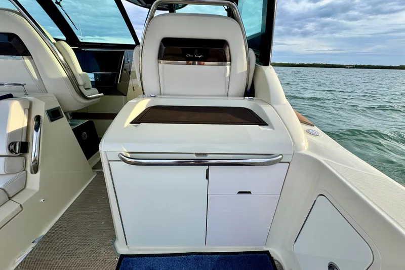 Slide: The Image of 2021 Chris-Craft Calypso 35 interior with luxurious seating and sleek design on open water. - 19
