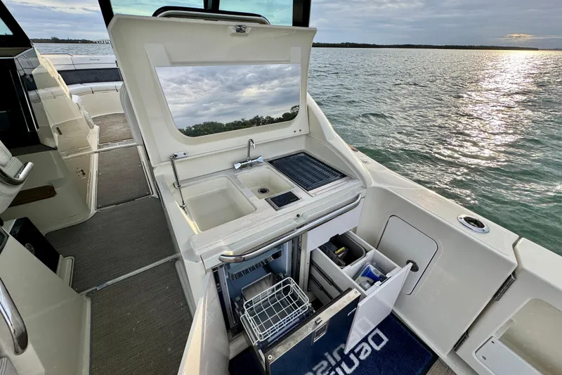 Slide: The Image of 2021 Chris-Craft Calypso 35 boat interior with kitchenette and ocean view. - 20