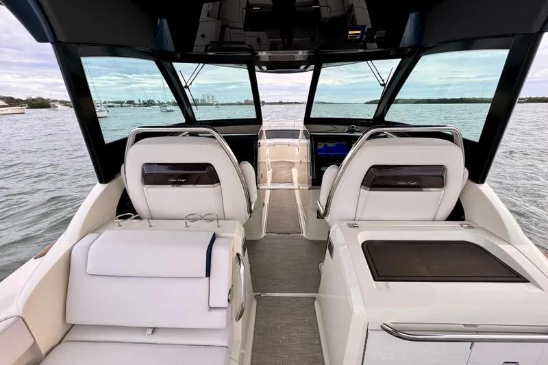 Slide: The Image of 2021 Chris-Craft Calypso 35 interior with luxurious seating and panoramic water views. - 21
