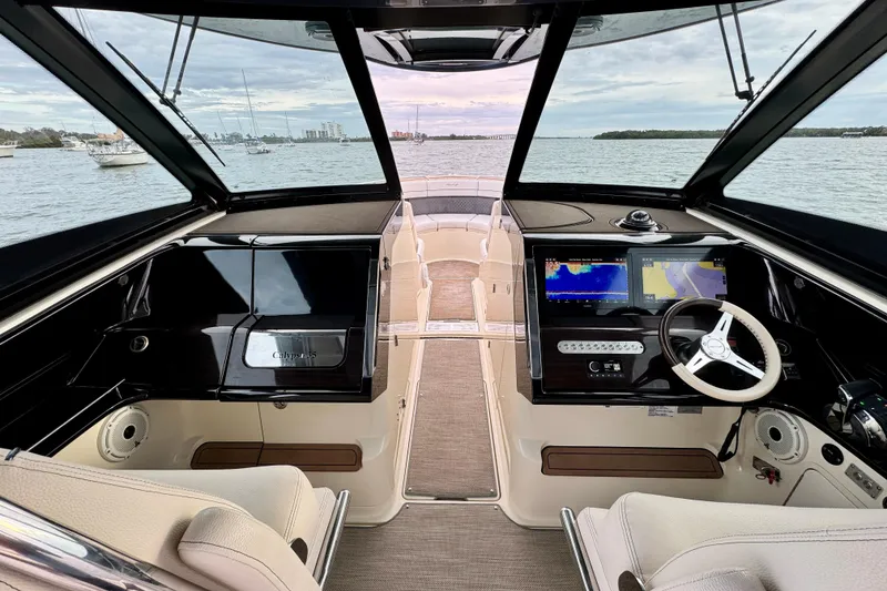 Slide: The Image of 2021 Chris-Craft Calypso 35 boat interior with navigation screens and steering wheel. - 22