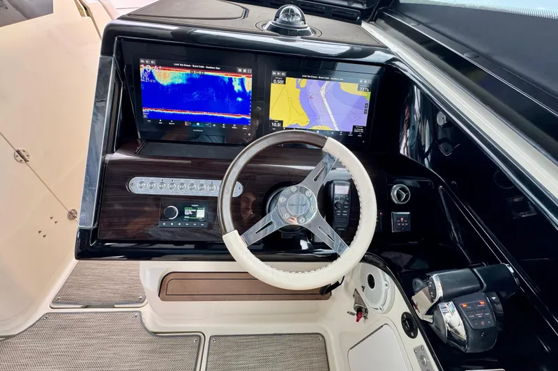 Slide: The Image of 2021 Chris-Craft Calypso 35 helm with dual navigation screens and leather-wrapped steering wheel. - 27