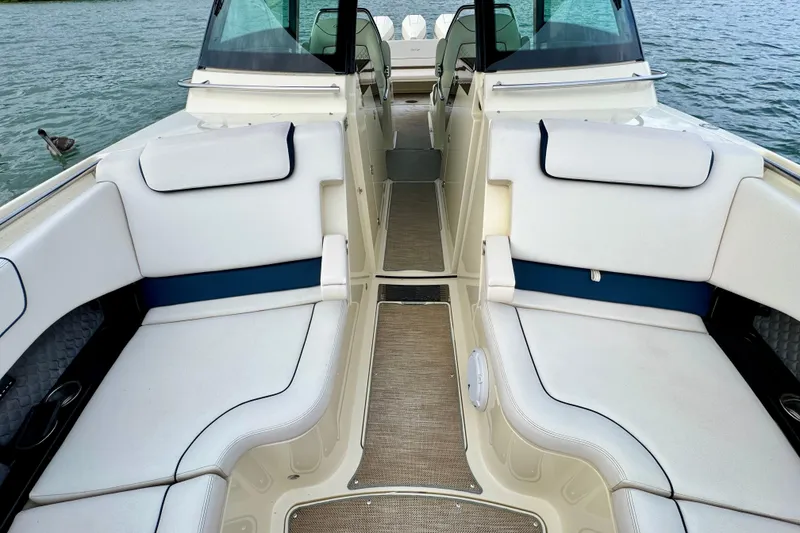 Slide: The Image of 2021 Chris-Craft Calypso 35 boat interior with white seating and blue accents. - 35