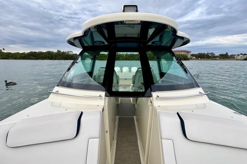 Slide: The Image of 2021 Chris-Craft Calypso 35 boat on calm water with scenic background. - 38