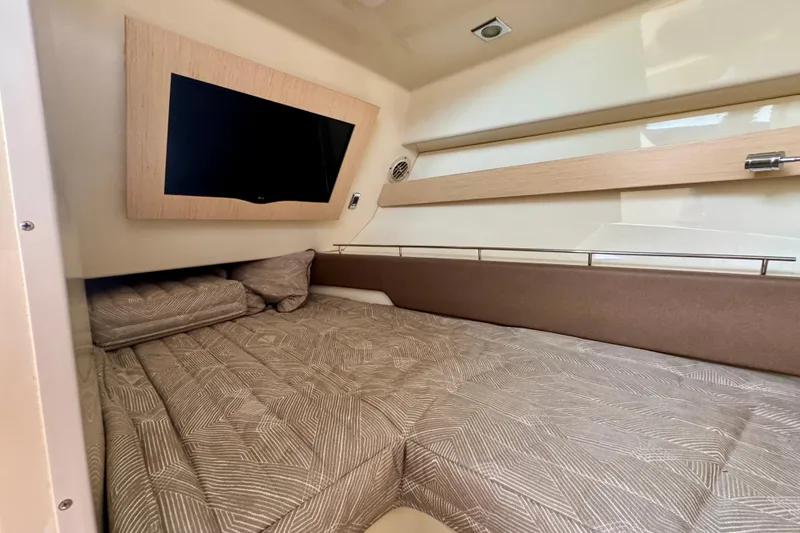 Slide: The Image of 2021 Chris-Craft Calypso 35 cabin interior with bed and mounted TV. - 40
