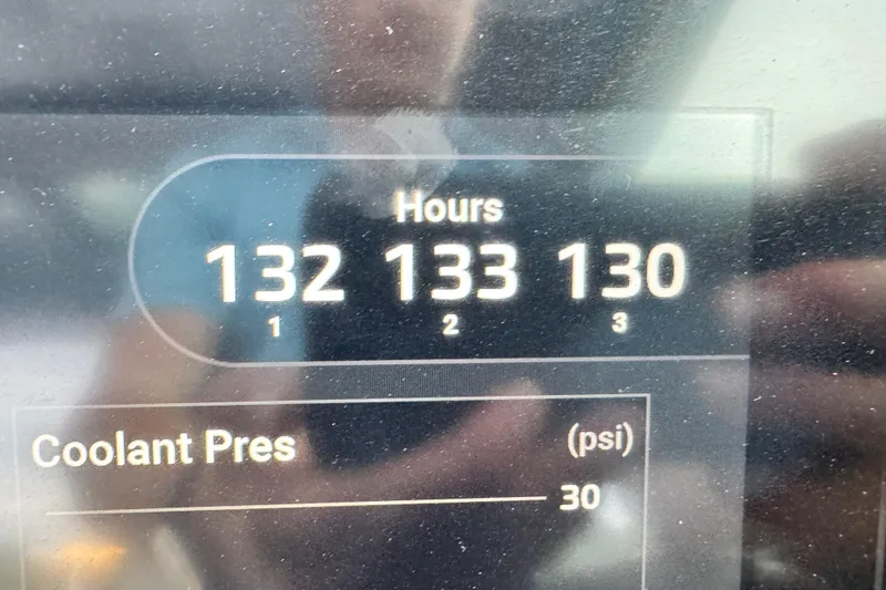 Slide: The Image of Display panel of 2021 Chris-Craft Calypso 35 showing engine hours and coolant pressure. - 50