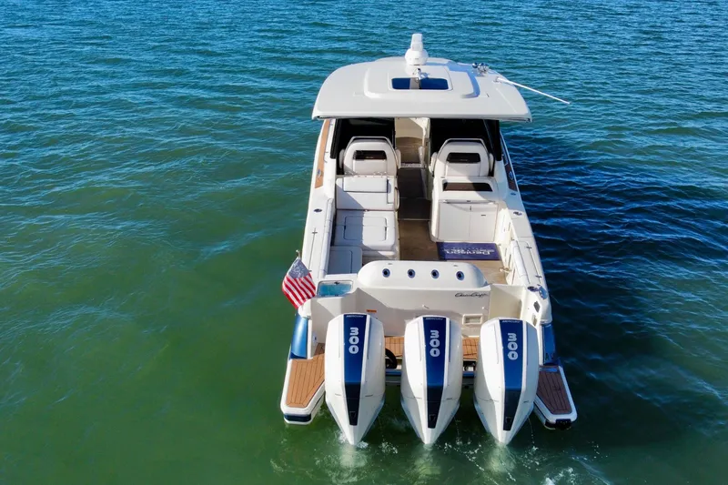 Slide: The Image of 2021 Chris-Craft Calypso 35 boat with triple outboard engines on open water. - 8