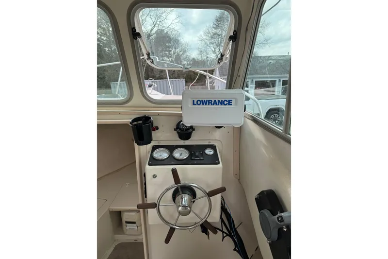 Slide: The Image of Interior of 2007 Cape Island Pilot boat with steering wheel and Lowrance navigation system. - 10