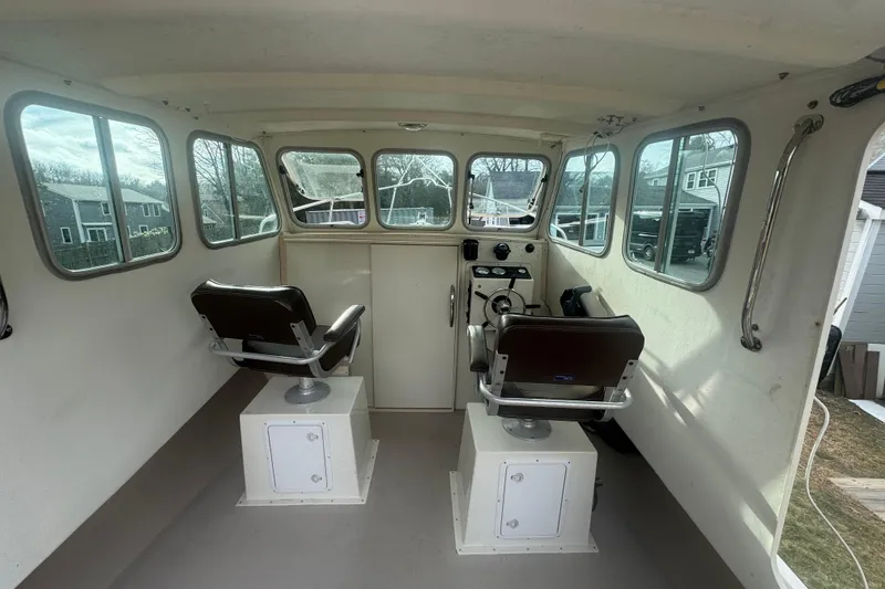 Slide: The Image of Interior of a 2007 Cape Island Pilot boat with dual seats and large windows. - 11