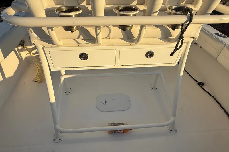 Slide: The Image of 2019 Regulator 23 boat console with rod holders and storage drawers. - 11