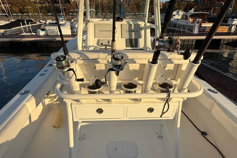 Slide: The Image of 2019 Regulator 23 boat with fishing rods and Garmin equipment at a marina. - 13