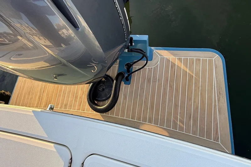 Slide: The Image of 2019 Regulator 23 boat with outboard motor and teak deck. - 15