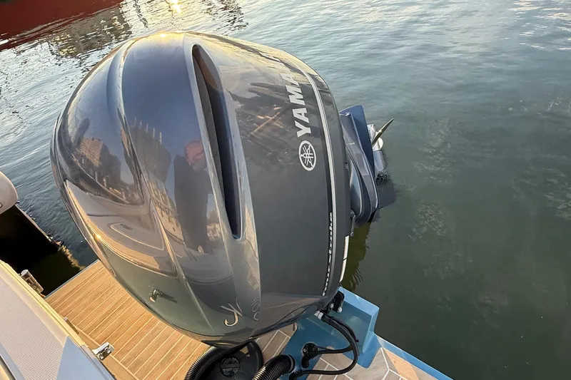 Slide: The Image of Yamaha outboard motor on 2019 Regulator 23 boat, docked by the water. - 17