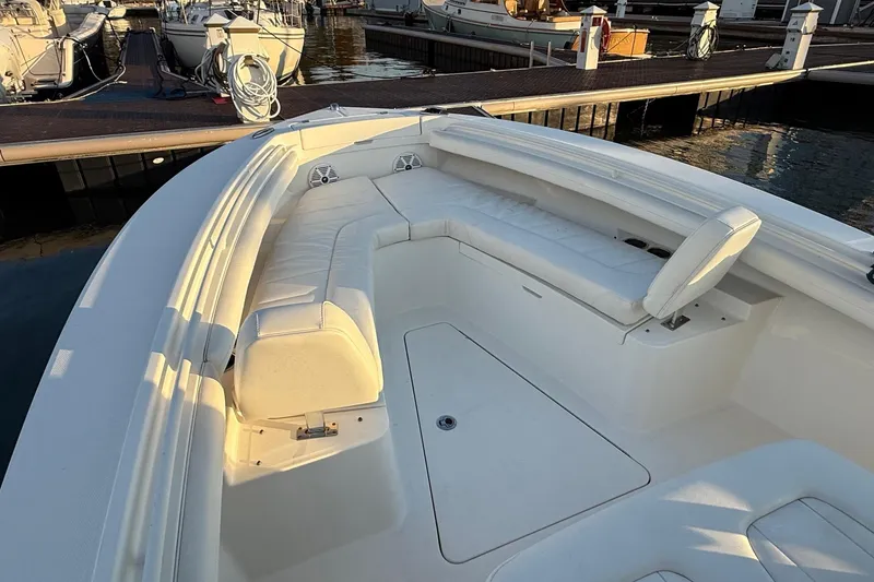 Slide: The Image of 2019 Regulator 23 boat interior with white seating at marina. - 18