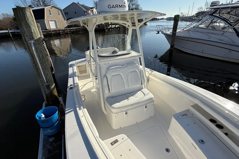 Slide: The Image of 2019 Regulator 23 boat docked, featuring Garmin equipment, in a serene marina setting. - 19