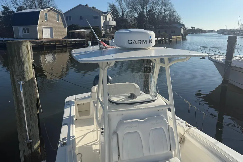 Slide: The Image of 2019 Regulator 23 boat docked by waterfront homes, featuring Garmin equipment. - 20