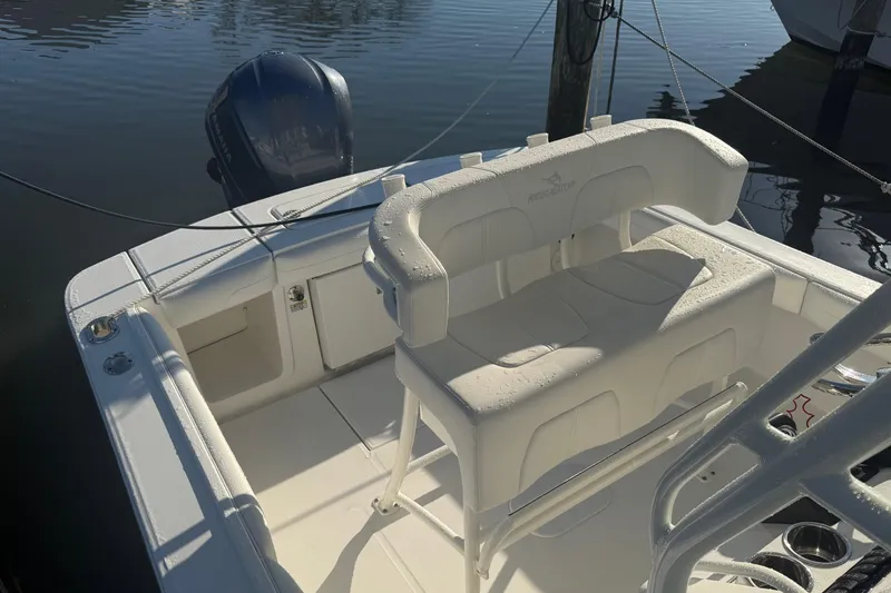 Slide: The Image of 2019 Regulator 23 boat interior with seating and outboard motor. - 21
