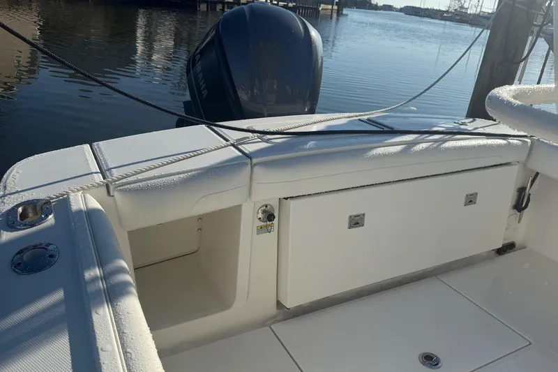 Slide: The Image of 2019 Regulator 23 boat interior with Yamaha engine, docked on calm water. - 25