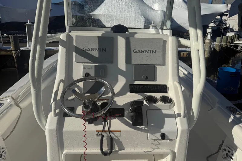 Slide: The Image of 2019 Regulator 23 boat console with Garmin navigation system and steering wheel. - 27