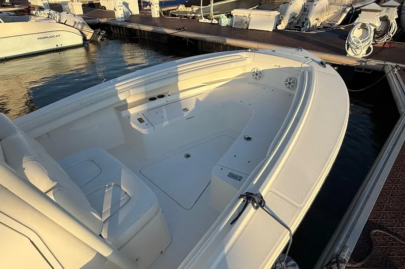 Slide: The Image of 2019 Regulator 23 boat docked, featuring spacious seating and sleek design. - 5