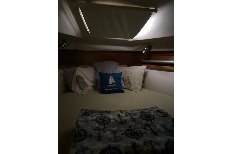 Slide: The Image of Cozy cabin interior of 2011 Catalina 355 sailboat with nautical-themed bedding. - 10