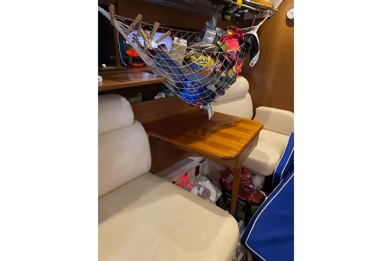 Slide: The Image of Interior of a 2011 Catalina 355 sailboat with seating and storage net. - 14