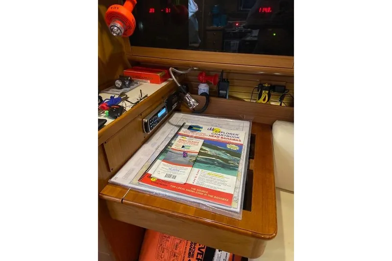 Slide: The Image of Navigation station on a 2011 Catalina 355 sailboat with charts and equipment. - 15