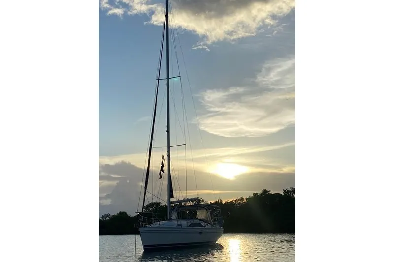 Slide: The Image of Sailboat Catalina 355 (2011) at sunset on calm water. - 23
