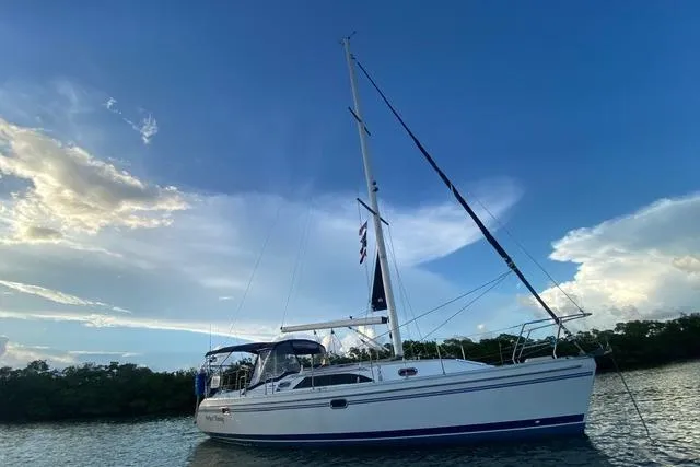 Slide: The Image of Sailboat Catalina 355, 2011 model, anchored on calm water under a blue sky. - 24