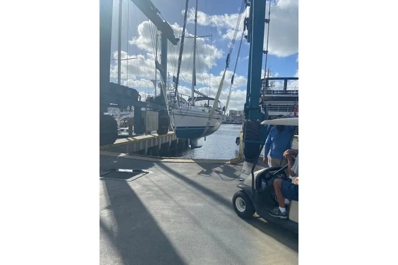 Slide: The Image of Catalina 355 sailboat being lifted at a marina, sunny day, 2011 model. - 26