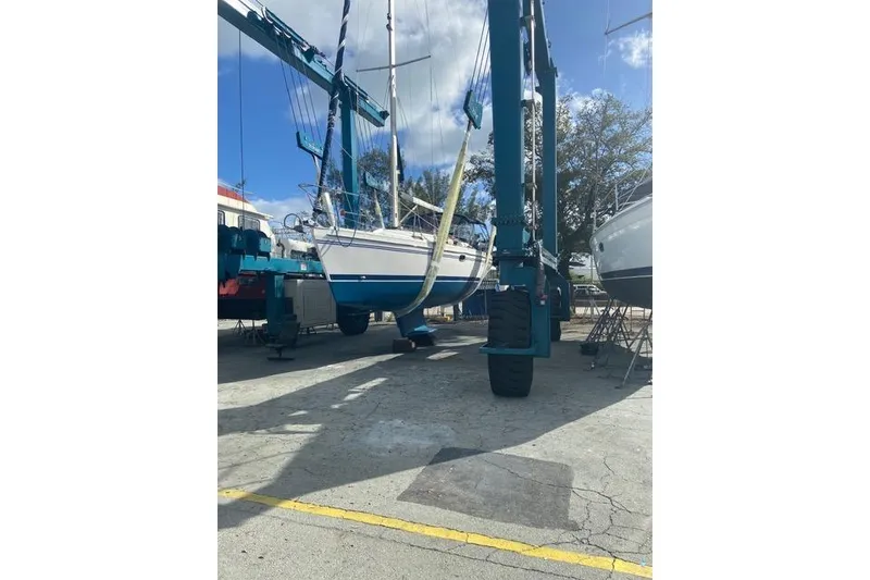 Slide: The Image of 2011 Catalina 355 sailboat in dry dock, supported by a boat lift. - 29