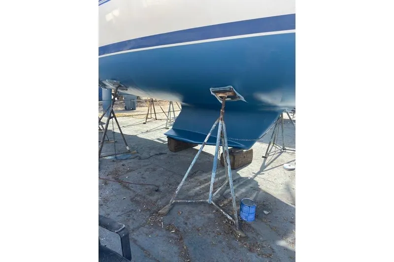 Slide: The Image of Catalina 355 sailboat from 2011 on stands, showing blue hull and keel. - 32