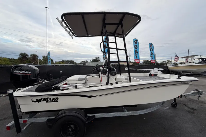 Slide: The Image of 2024 Mako Pro Skiff 15 CC boat with Mercury engine on display. - 1