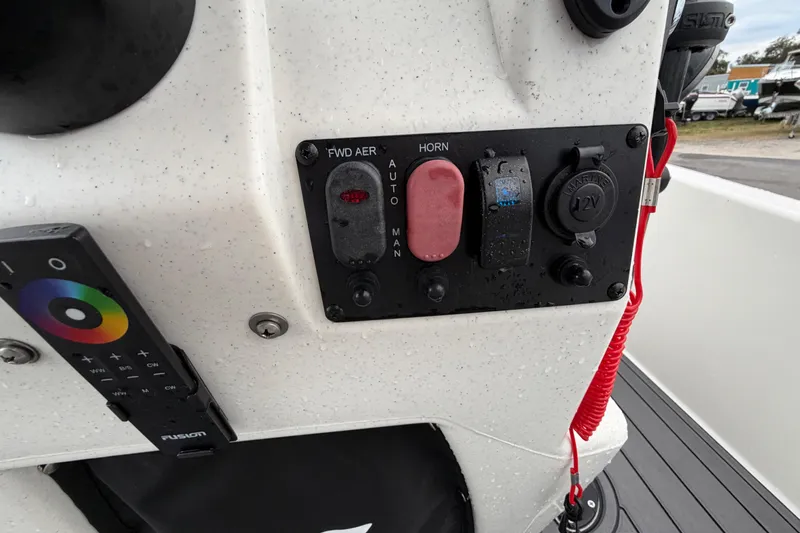 Slide: The Image of 2024 Mako Pro Skiff 15 CC control panel with switches and remote. - 16