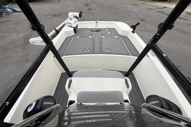Slide: The Image of 2024 Mako Pro Skiff 15 CC interior view with seating and storage compartments. - 17