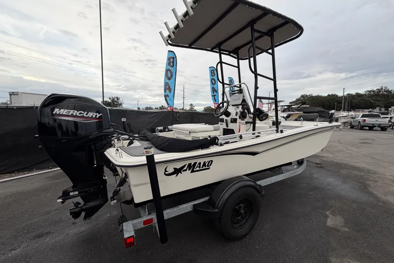 Slide: The Image of 2024 Mako Pro Skiff 15 CC boat with Mercury engine on trailer. - 2