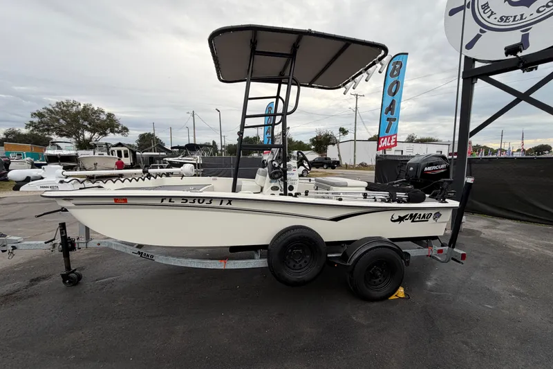 Slide: The Image of 2024 Mako Pro Skiff 15 CC boat on trailer, displayed outdoors for sale. - 8