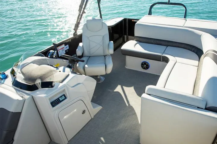 Slide: The Image of 2018 Crest Classic 250 SLS boat interior with beige seating and wood flooring. - 9