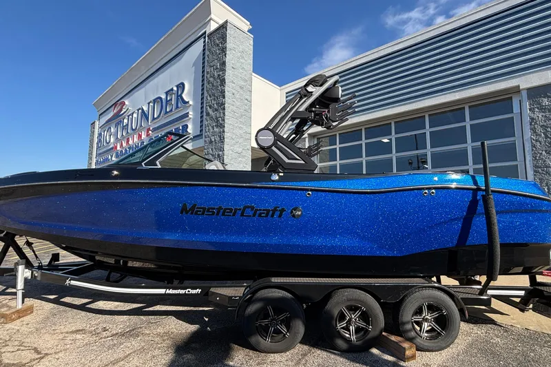 The Image of 2022 MasterCraft X26 boat in vibrant blue at Big Thunder Marine Center. - 1