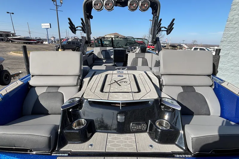 Slide: The Image of 2022 MasterCraft X26 boat interior with gray seating and sleek design. - 11