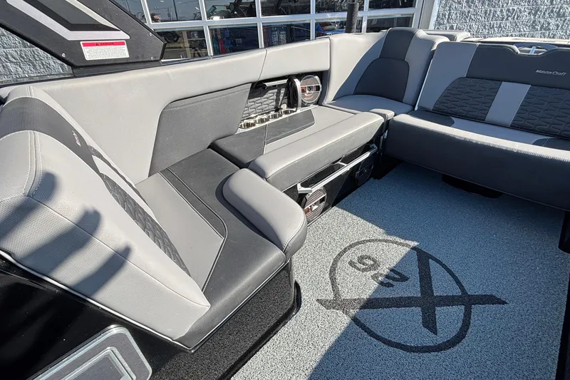 Slide: The Image of 2022 MasterCraft X26 boat interior with gray seating and stylish design. - 18
