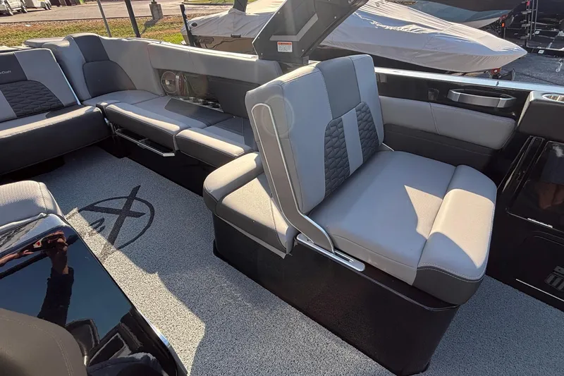 Slide: The Image of 2022 MasterCraft X26 boat interior with luxurious gray seating and modern design. - 21