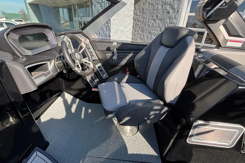 Slide: The Image of 2022 MasterCraft X26 boat interior with sleek steering and modern seating design. - 22